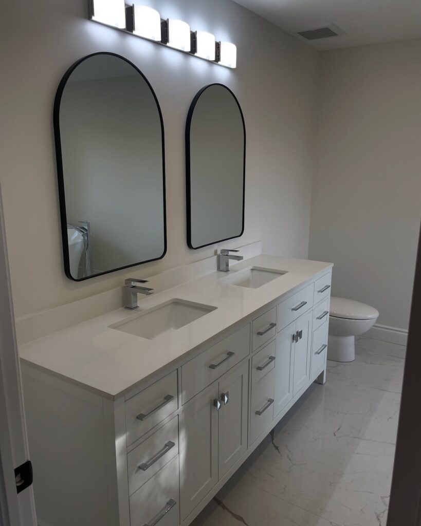a bathroom with two sinks and a toilet