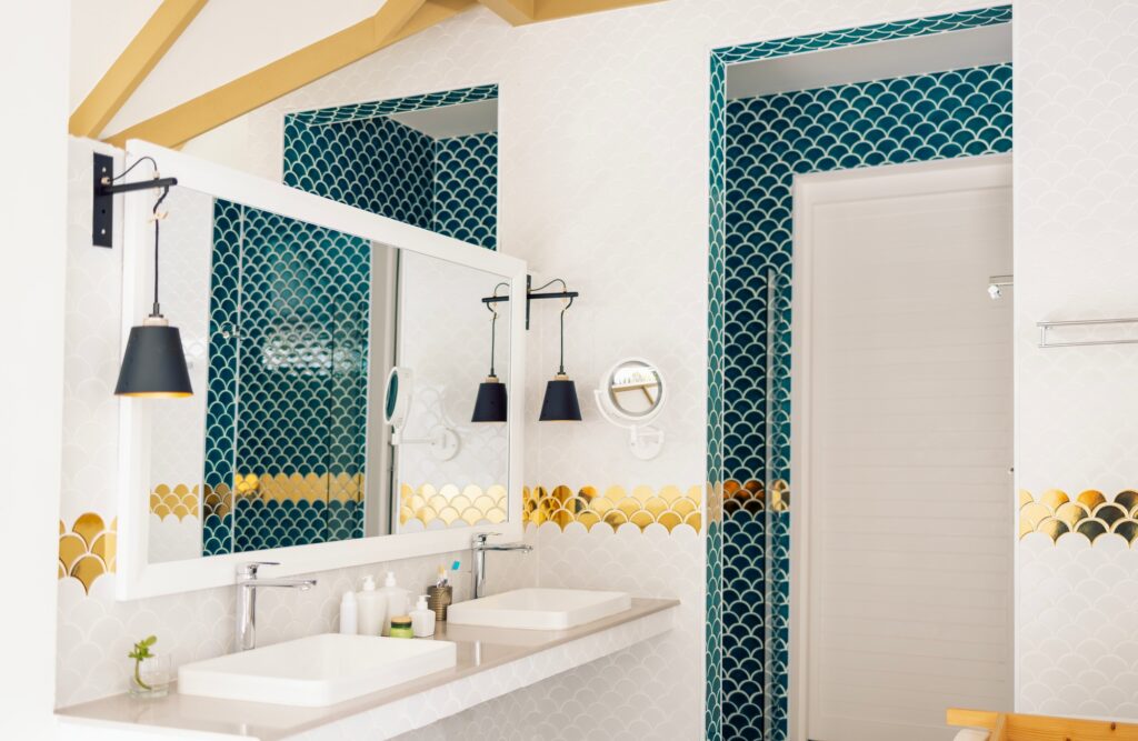 A stylish bathroom features a mix of blue and white fish scale tiles.