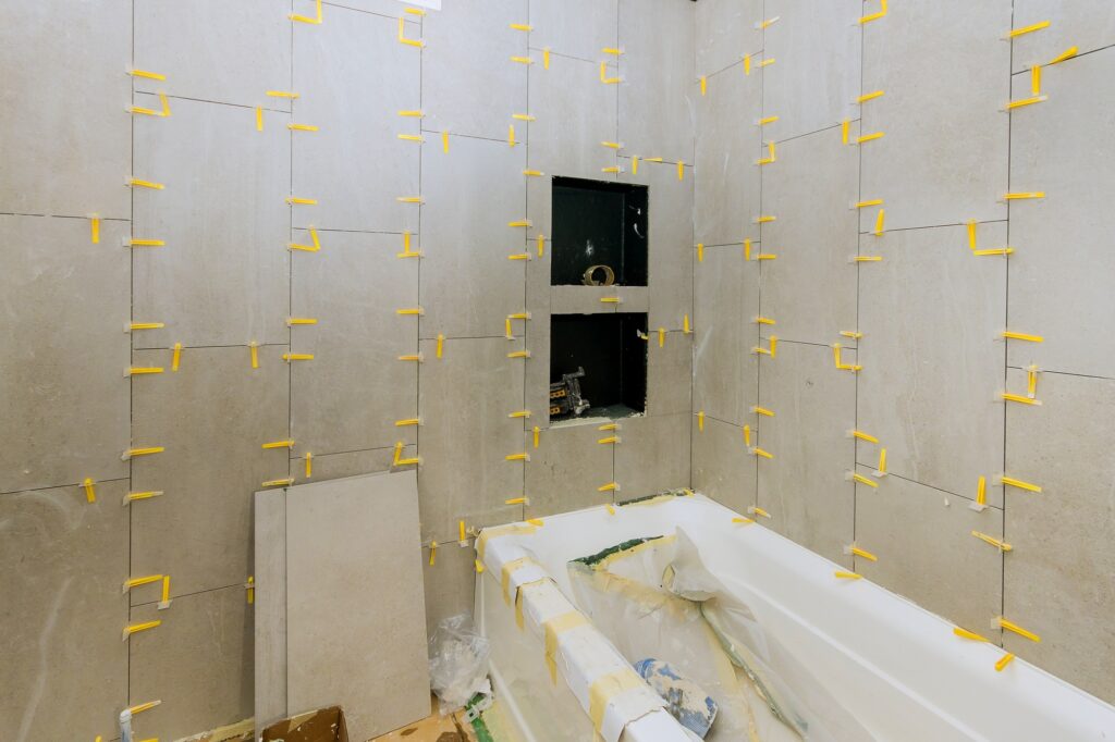 Construction work installing ceramic tile on reconstruction of bathroom during or renovation