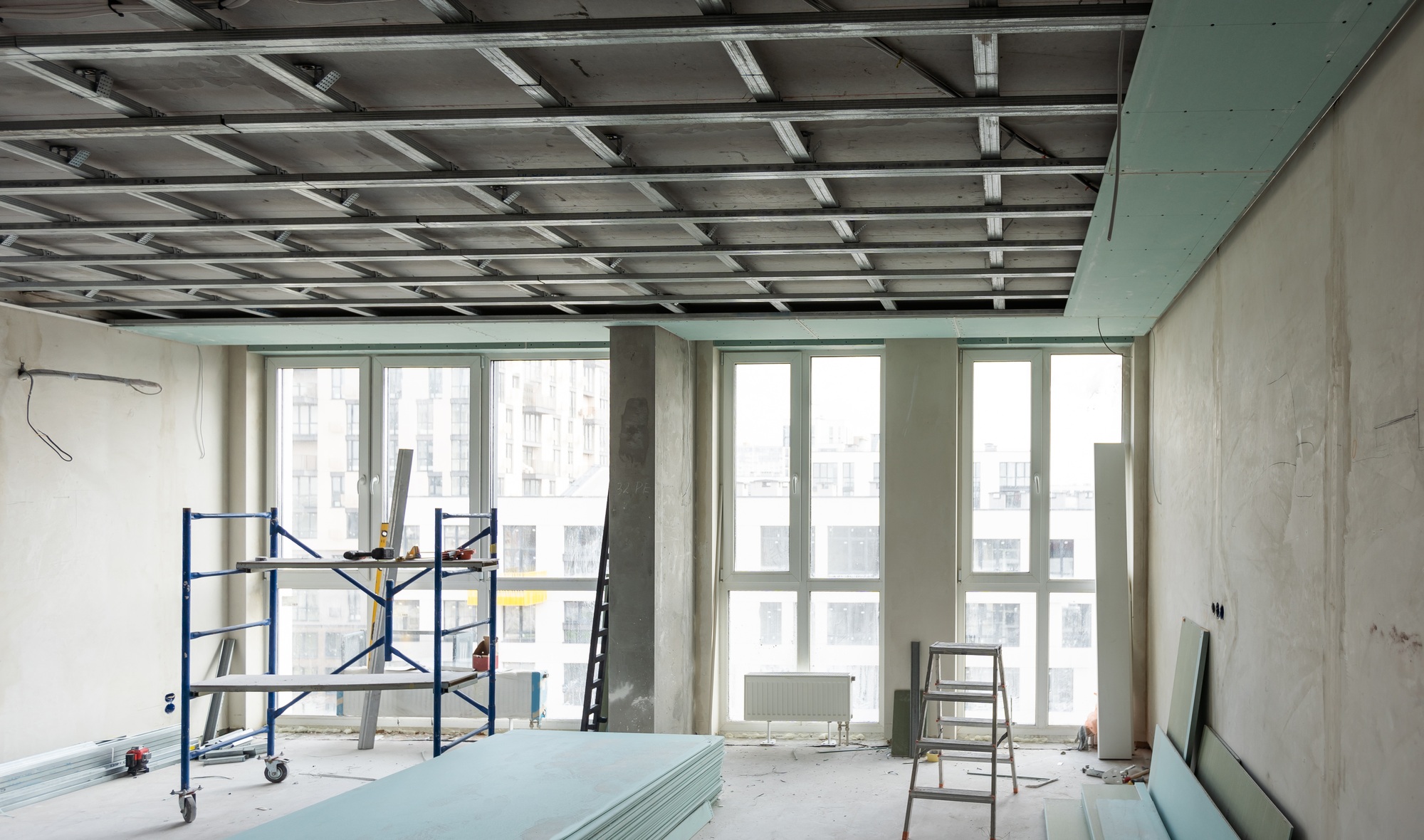 Construction worker, making walls from gypsum plasterboard or drywall