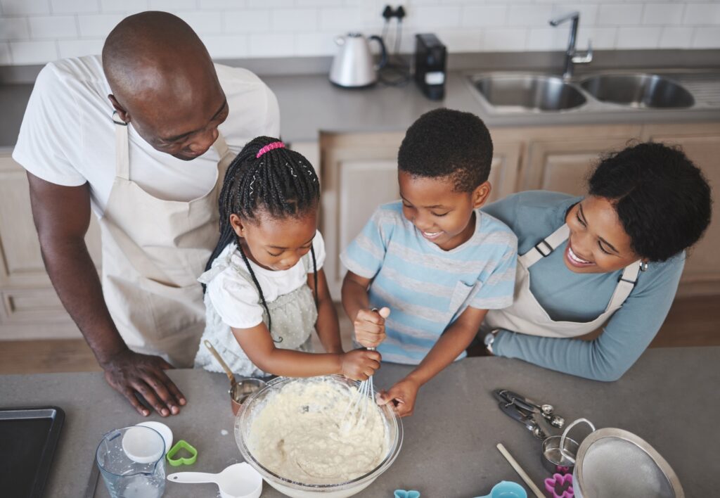 Shot of a family baking together in the kitchen